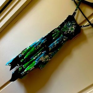 Dress short on the middle longer on the sides. Stretchy popcorn style on top.